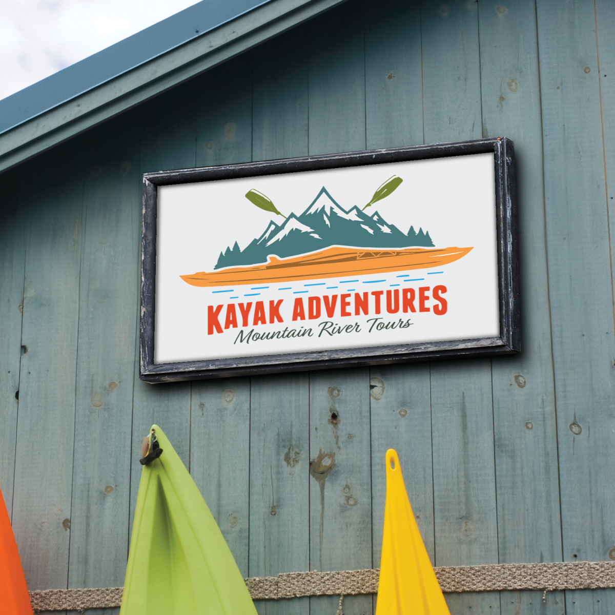 201HTAP_Image_square A photo of the side of a building. It is made of grey wood. There is a white sign with the text "Kayak Adventures" written on the sign, with in illustration of some green mountain and an orange kayak. The sign is printed on GF 201HTAP.