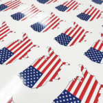 A photo of kiss-cut stickers of the contiguous 48 states of the USA encompassing the USA flag. Printed on GF 203.