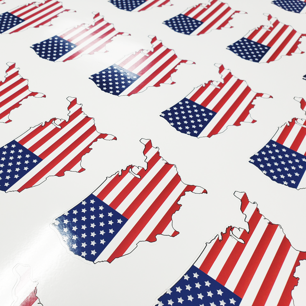 GF 203_Image_square A photo of kiss-cut stickers of the contiguous 48 states of the USA encompassing the USA flag. Printed on GF 203.