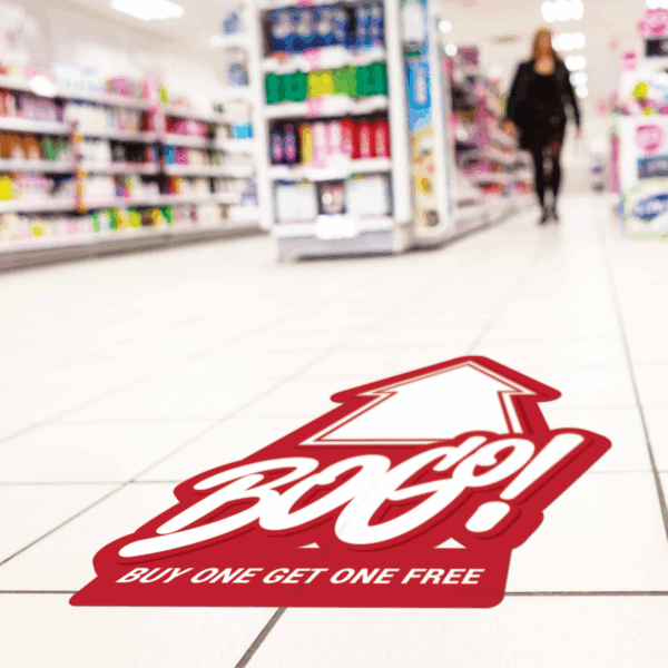Photo of a floor graphic printed on GF 210 on a tiled floor in a store that is red with a white arrow and white text that reads, "BOGO! Buy One Get One."