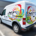 A photo of a white van with a decal that looks like paint splashes along with a black logo for a business called ACP Painting , LLC. The website URL is underneath. This decal was printed on GF 333.
