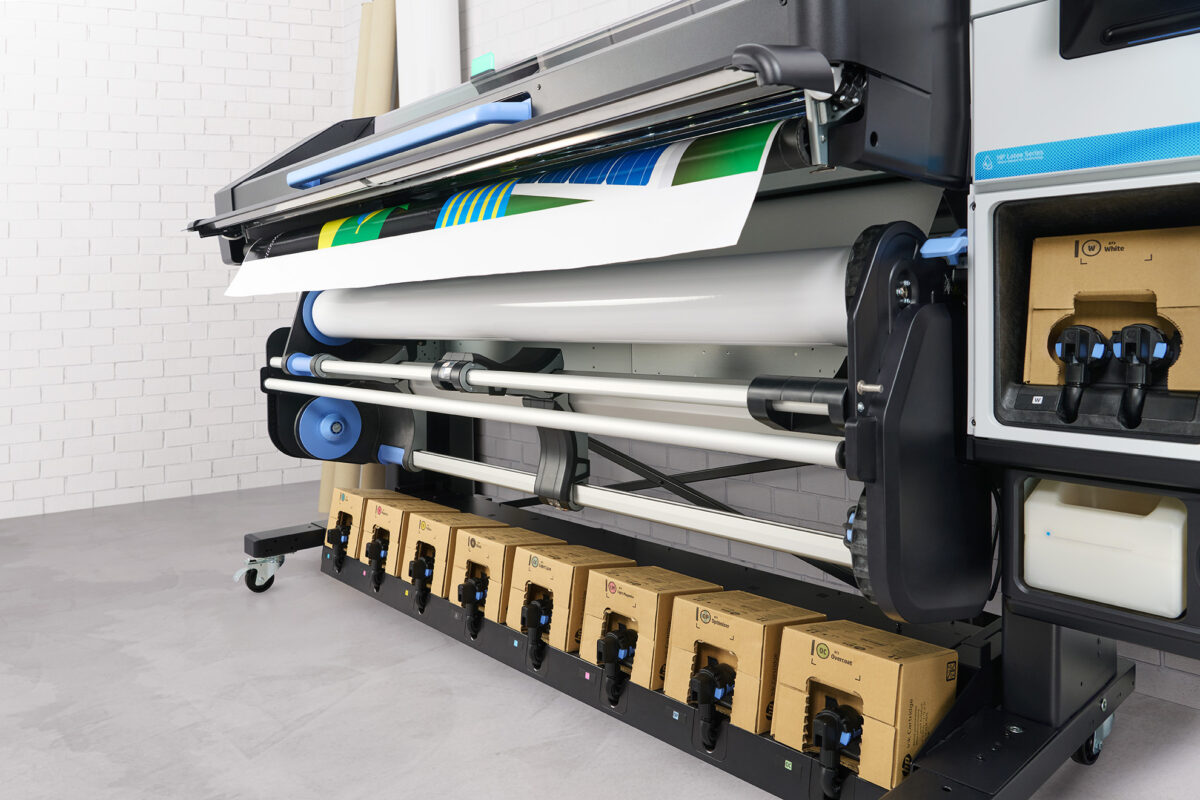 A photo of HP Latex 830W with printed paper coming out of of.