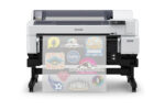 Epson SureColor G6070 35 DTFilm Printer with a roll of clear film coming out. Various sports logos are printed on the film.