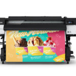 A photo of the Epson SureColor S7170 from the front. It is printing a large job with yellow, teal, and magenta with pictures of icecream in colorful, paper cups.
