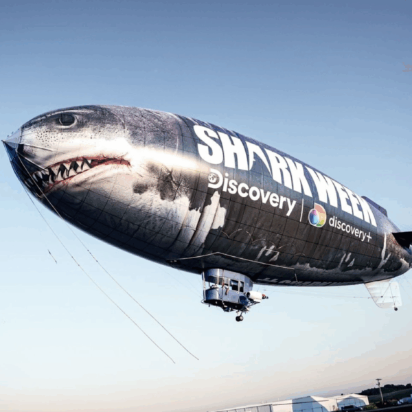 A photo of the Discovery Channel Shark Week blimp. It is printed to look like a shark. Printed on GF 224.
