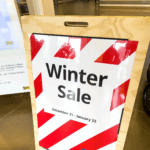 A photo of a sing in a wood frame that says, "Winter Sale," in black all caps with red and white stripes. An example image for GF 160