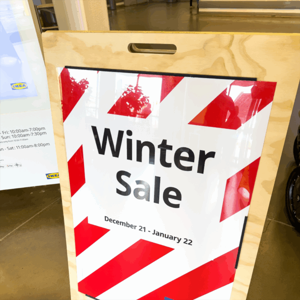 A photo of a sing in a wood frame that says, "Winter Sale," in black all caps with red and white stripes. An example image for GF 160