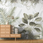 A photo of a room with wooden floors. There is an oddly-shaped piece of furniture with two columns of drawers, the left column with four drawers and the right with only one. There are books sitting on the right side. The wallpaper is white with different types of green plants on it, mimicking a jungle. The wallpaper was printed on GF 227.