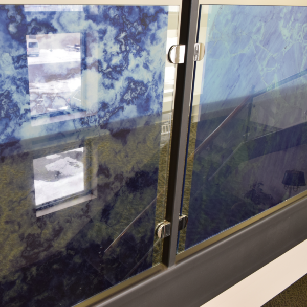 A photo of windows overlooking the lobby and staircase of a business. There is an opaque blue marble texture on the glass. The texture was printed on GF 247.