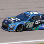 A photo of a race car on a track. It is blue and black with a small amount of green. It has the number 78 on the sides and roof, and the General Formulations logo on the hood and sides. The wrap on this car was printed on GF 830.