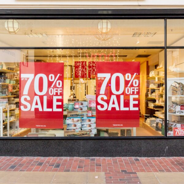 A photo of the window of a storefront. There are large red decals in the window that say, "70% off sale," in white. The decals are printed on GF 365OP.
